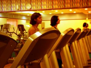 Inside a gym, people on treadmills